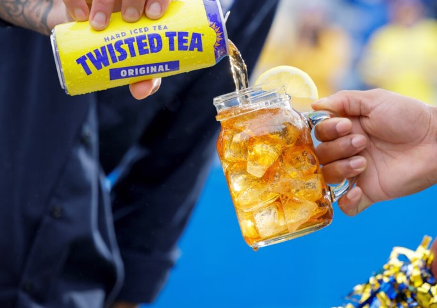 Twisted Tea Original hard iced tea poured over ice with a lemon garnish.